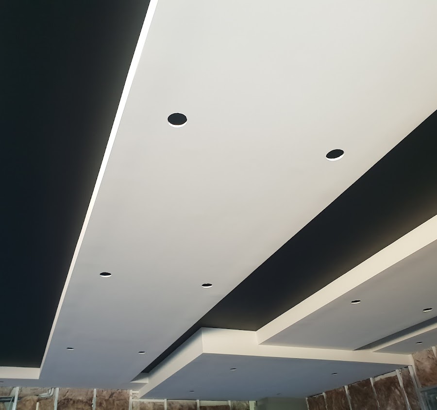 Two-tone black and white feature ceiling with recessed lighting