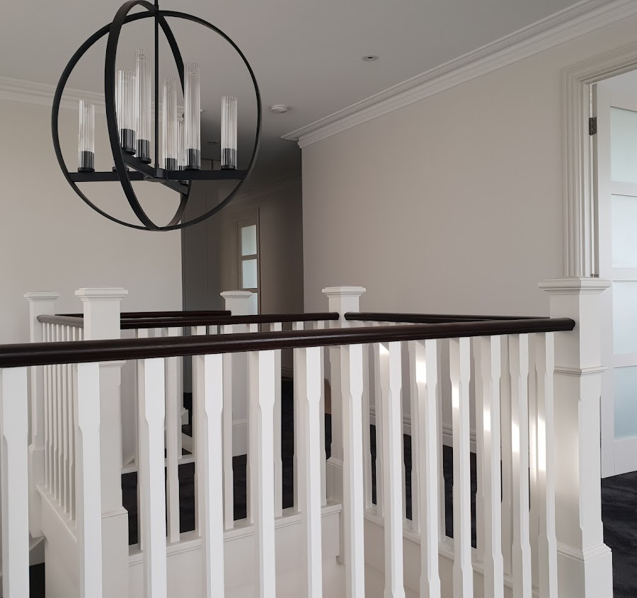Painted staircase landing with white balustrade and crisp trim